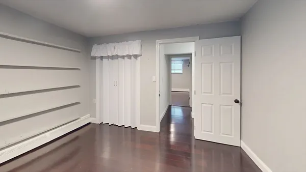 a view of a room with wooden floor