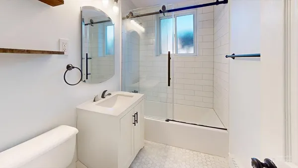 a bathroom with a sink toilet and shower