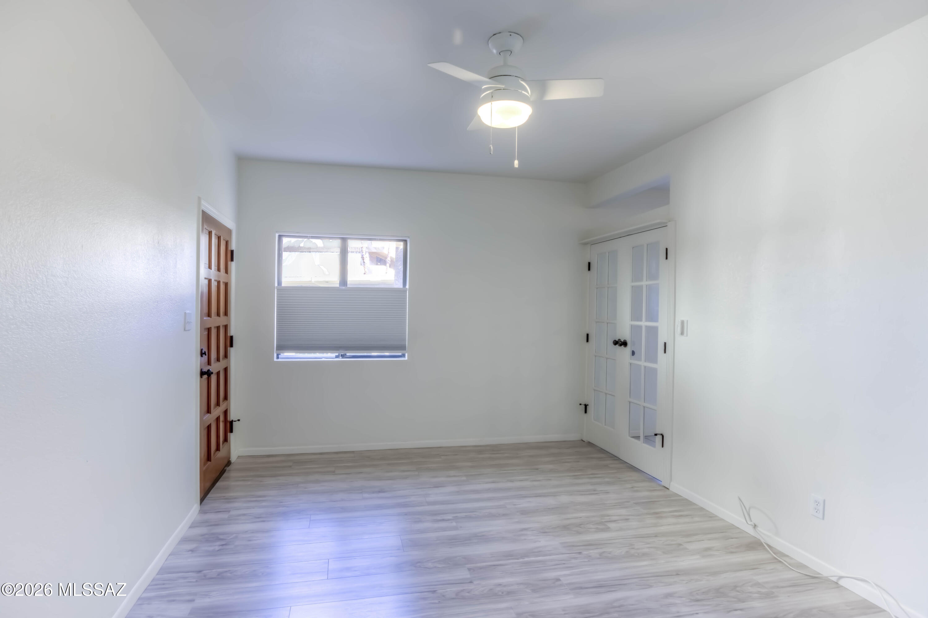 5500 North Valley View Road, Unit 123 Tucson, AZ 85718 - Photo 22 of 36 an empty room with wooden floor and window
