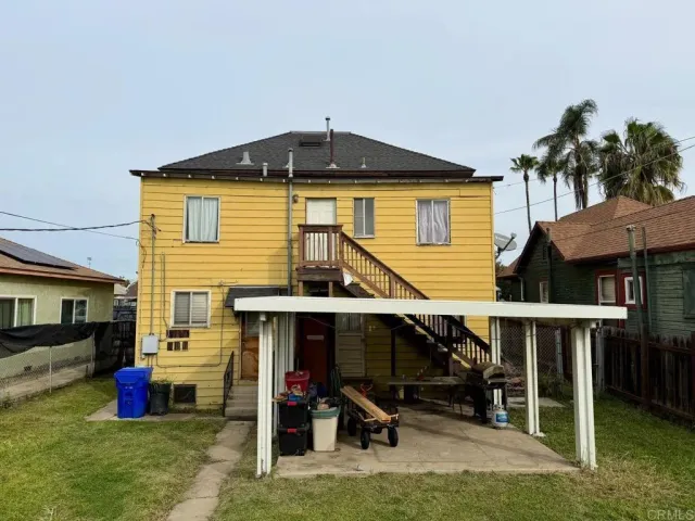 a view of a house with a patio and a yard