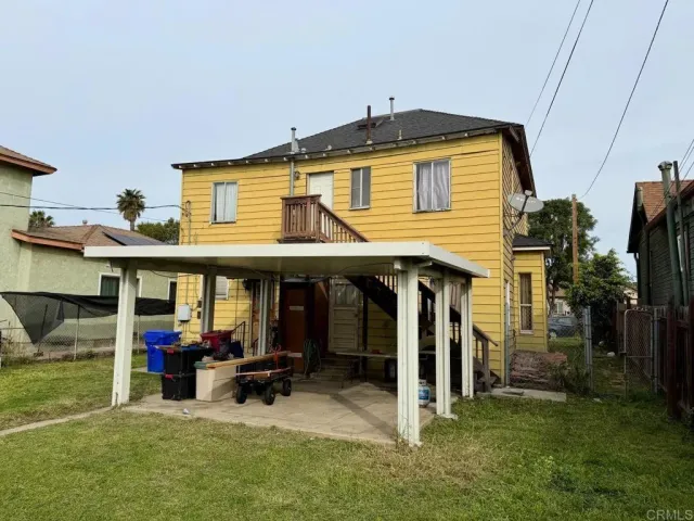 a view of a house with a porch and furniture