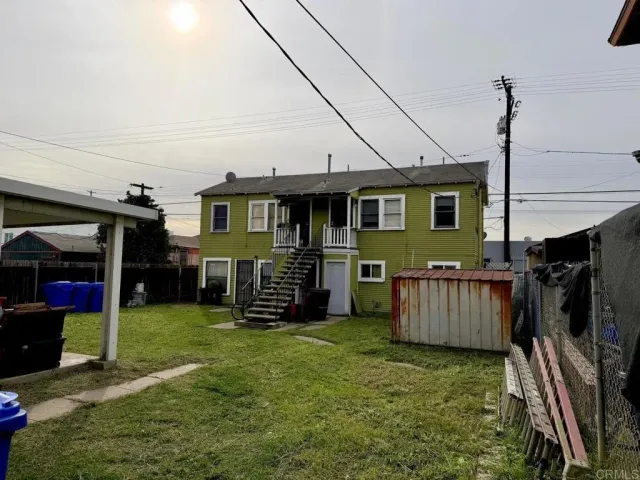 a view of a house with a yard and sitting area