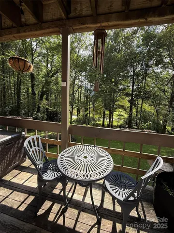 a view of a chairs and table in patio with wooden fence