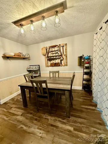 a view of a dining area with furniture and a rug