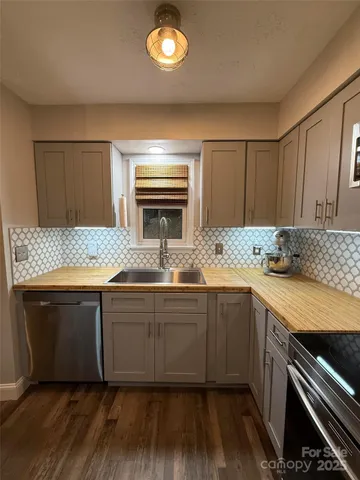 a kitchen with granite countertop a sink and a stove