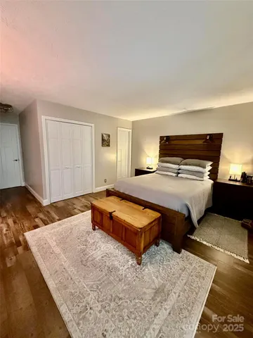 a bedroom with furniture and a wooden floor