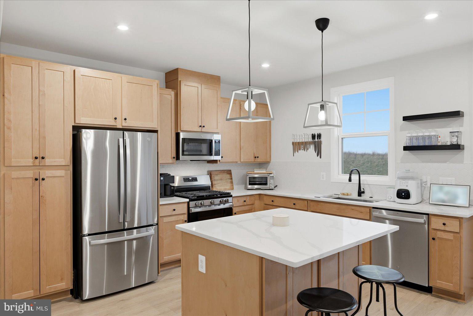 121 Checkerspot Way White Post, VA 22663 - Photo 3 of 65 a kitchen with stainless steel appliances granite countertop a sink a stove a refrigerator and island