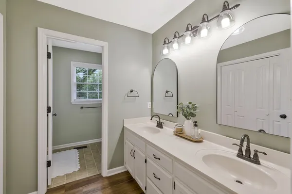 a bathroom with a double vanity sink and a mirror