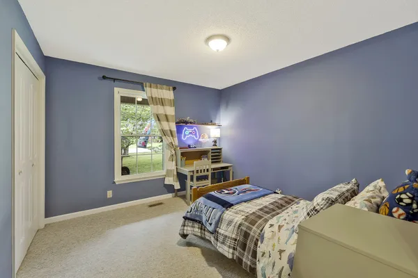 a bedroom with a bed and a window