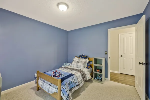 a bedroom with a bed and a table in it