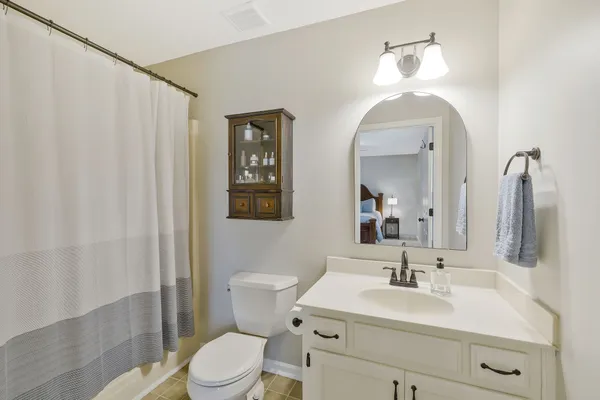 a bathroom with a toilet a sink and a mirror