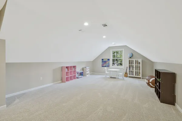 an empty room with furniture and a flat screen tv