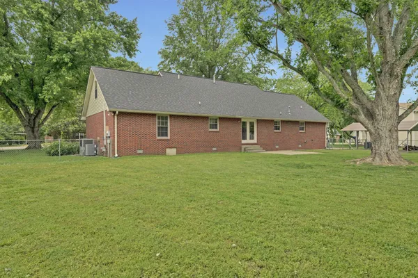 a front view of house with yard and trees