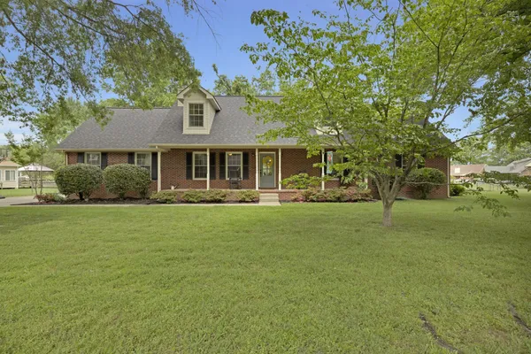 a front view of a house with a garden