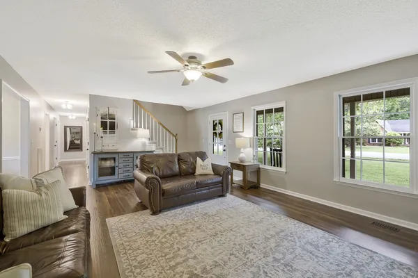 a living room with furniture and a large window