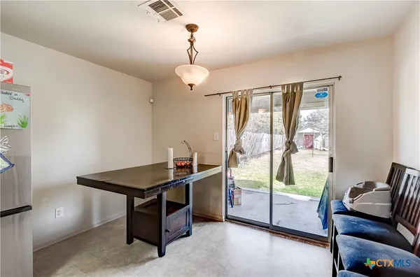 a kitchen view with stainless steel appliances refrigerator stove microwave and cabinets