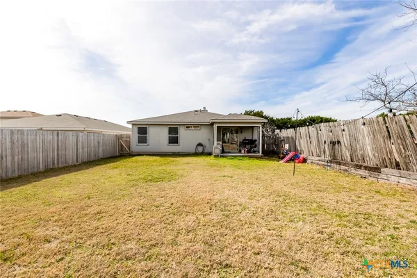 a front view of house with yard and swimming pool