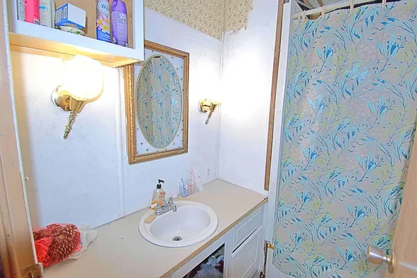 a bathroom with a sink and a mirror