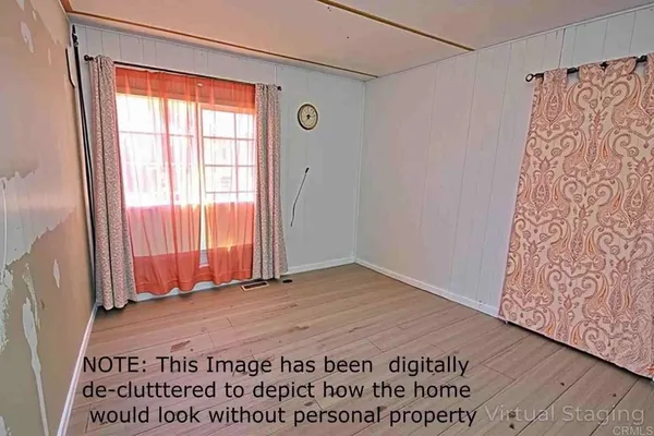 a view of a room with a window and a wooden door