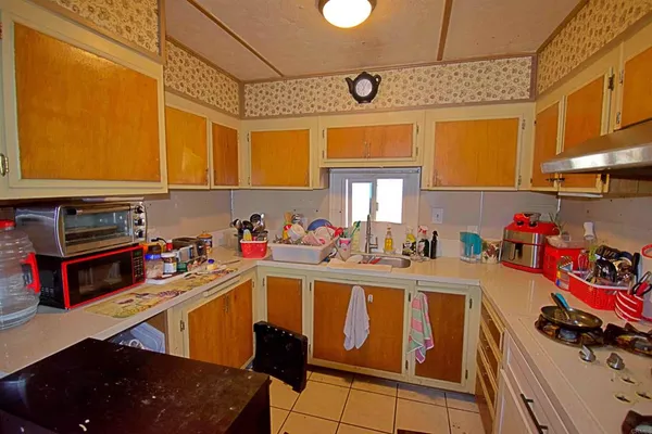 a kitchen with stainless steel appliances granite countertop a sink dishwasher and cabinets with wooden floor