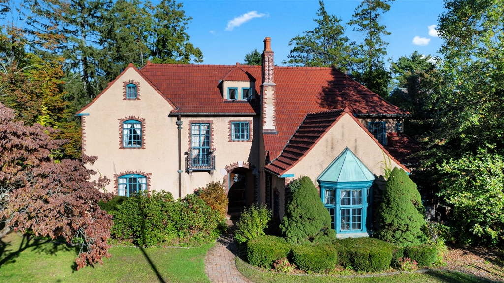 a view of a house with brick walls and trees