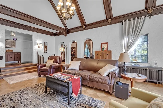 a bathroom with a tub a sink and a large mirror
