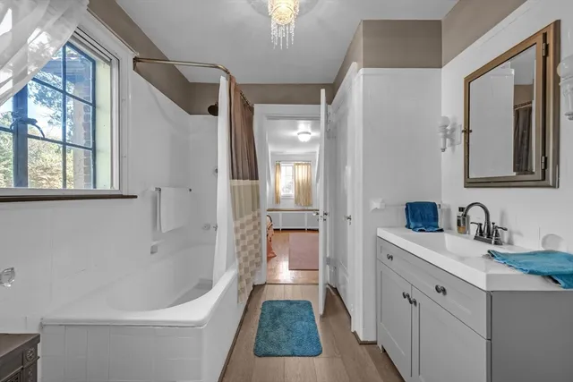 a kitchen that has a lot of cabinets in it and wooden floor