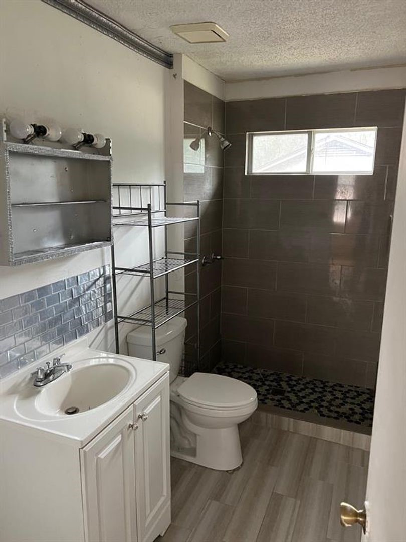 3058 Old Colony Road Huntsville, TX 77320 - Photo 11 of 14 a bathroom with a sink toilet and shower