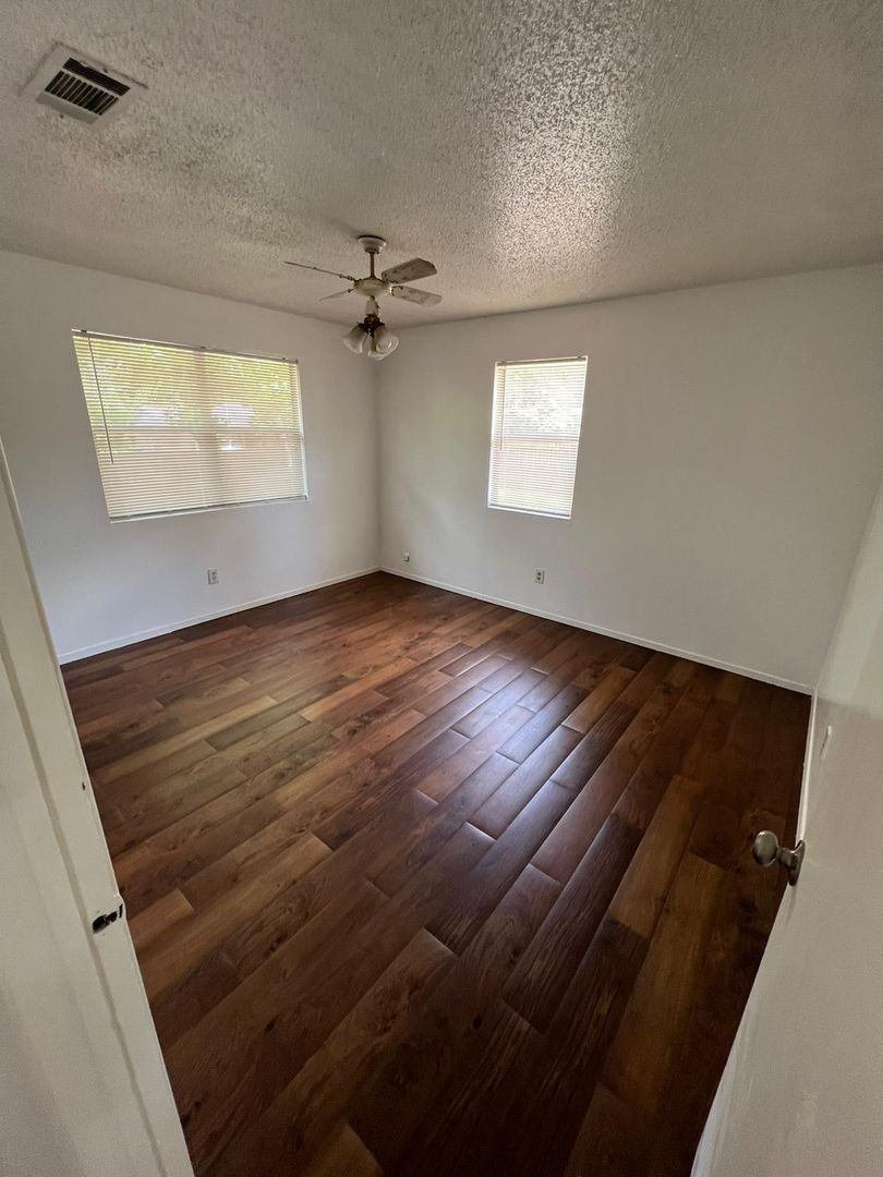3058 Old Colony Road Huntsville, TX 77320 - Photo 8 of 14 wooden floor in an empty room