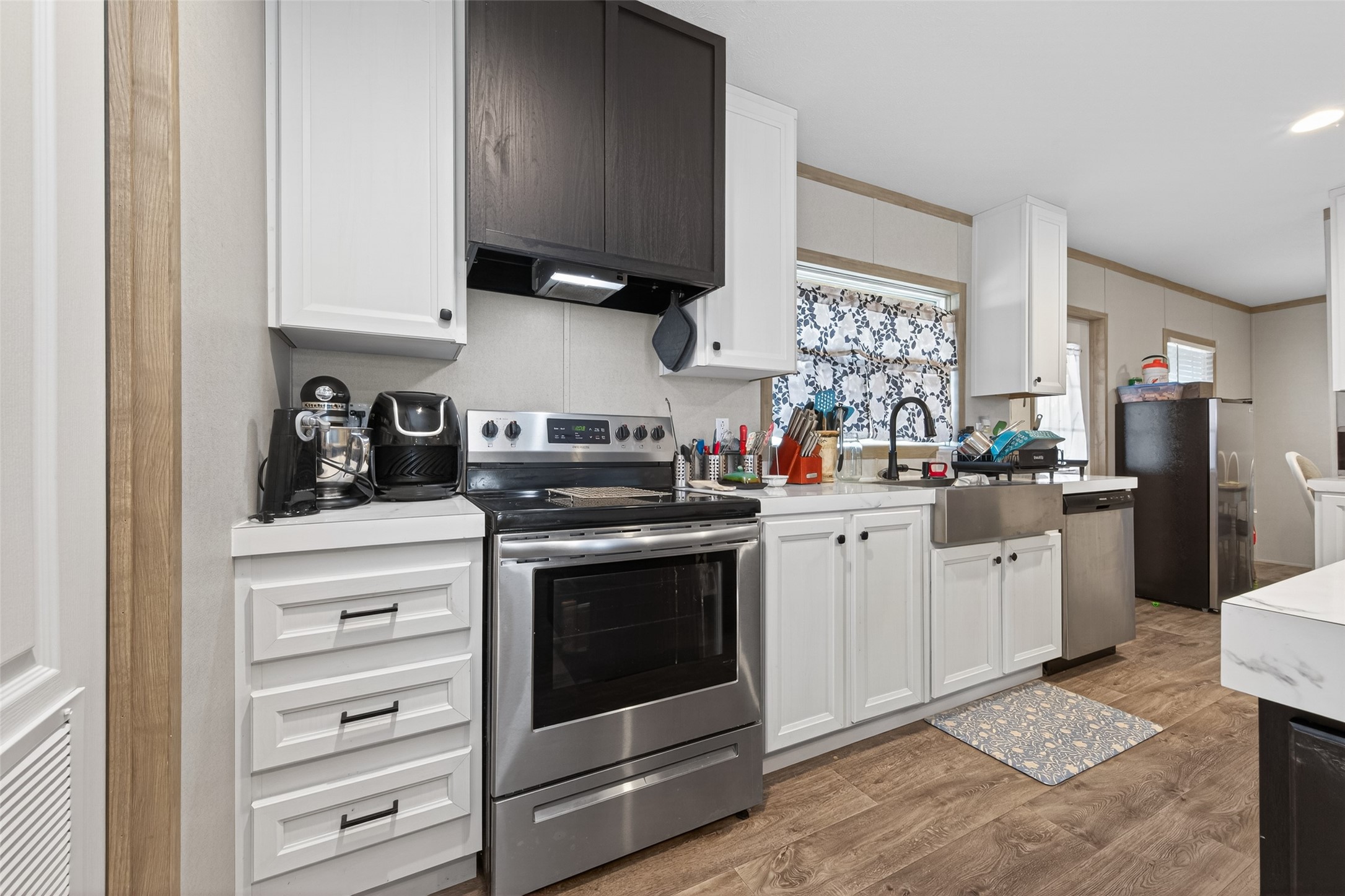 1375 Road 5735 Cleveland, TX 77327 - Photo 15 of 49 a kitchen with white cabinets stainless steel appliances and sink