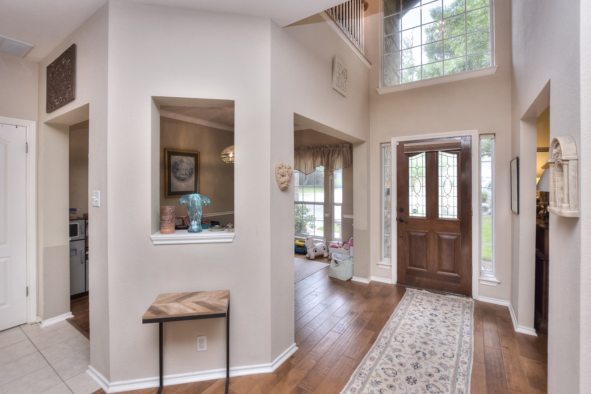 1609 Colton Way Cedar Park, TX 78613 - Photo 24 of 24 A spacious entry foyer features rich hardwood flooring and a towering window illuminating the grand entryway.