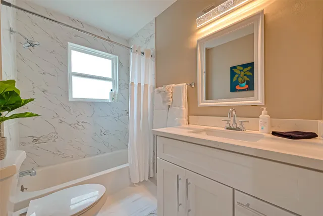 a bedroom with a bed and a tv on dresser