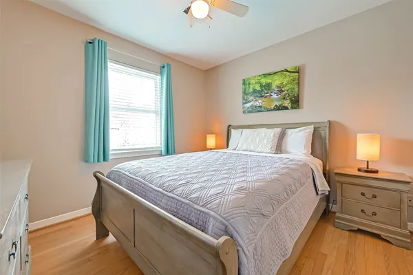 a bedroom with a bed and a chandelier