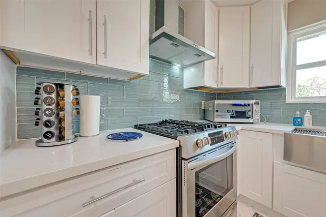 a stove top oven sitting inside of a kitchen