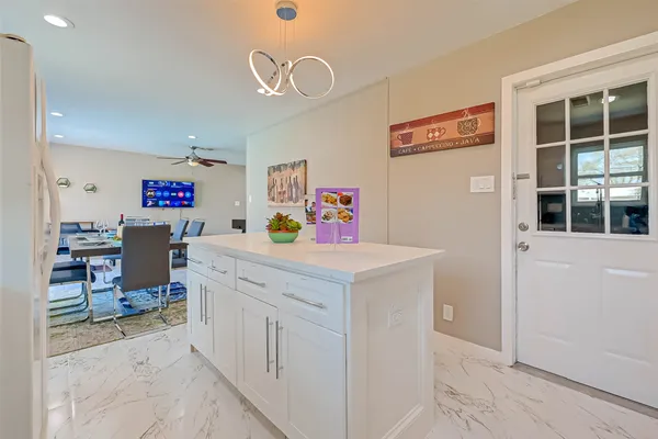 a kitchen with stainless steel appliances a stove refrigerator sink and cabinets