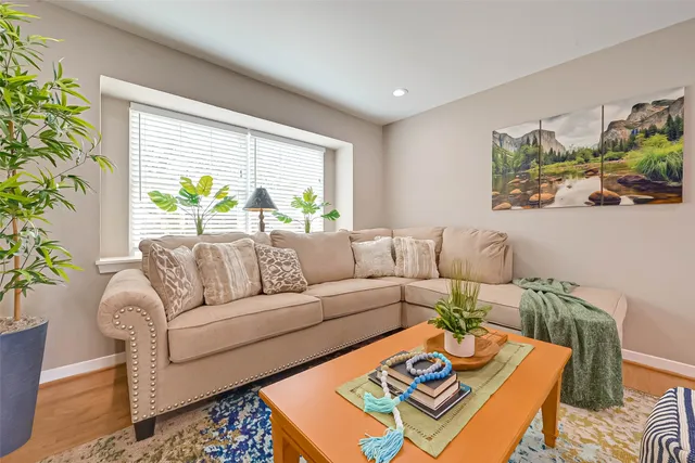 a living room with furniture and a potted plant