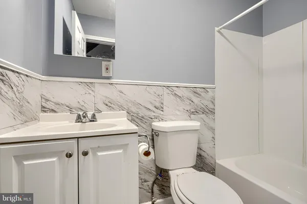 a white toilet sitting next to a bathroom sink