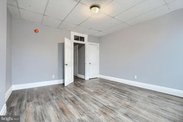 a view of an empty room with wooden floor