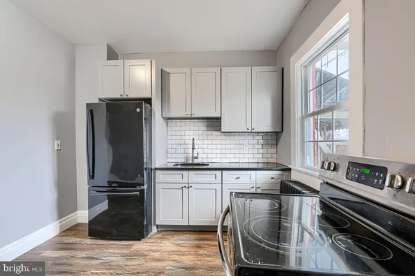 a kitchen with a refrigerator stove and sink
