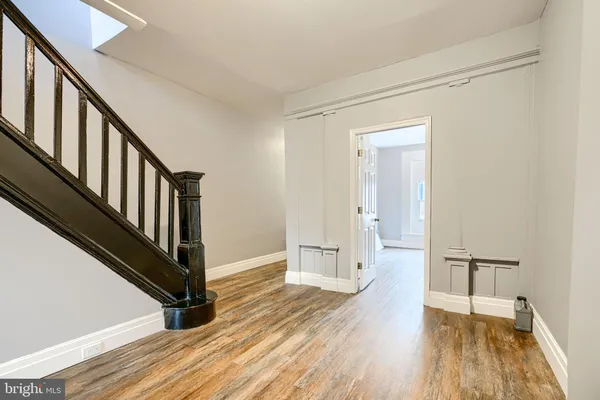 a view of an entryway with wooden floor and staircase
