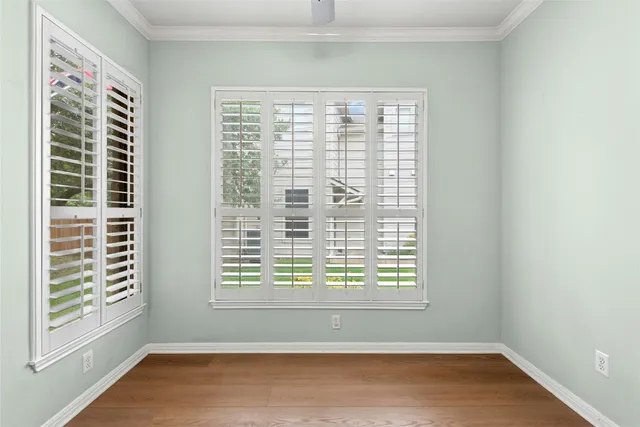 a view of a livingroom with wooden floor a fireplace and windows