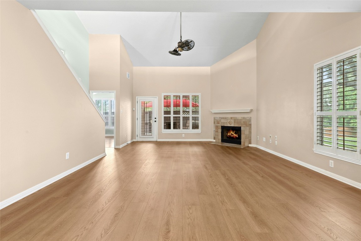 7500 Shadowridge Run, Unit 34 Austin, TX 78749 - Photo 12 of 39 a view of a livingroom with wooden floor a fireplace and windows