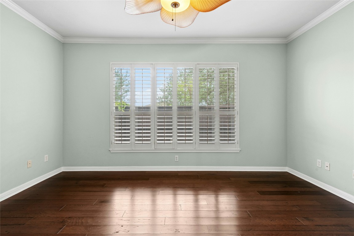 7500 Shadowridge Run, Unit 34 Austin, TX 78749 - Photo 18 of 39 a view of an empty room with wooden floor and a window