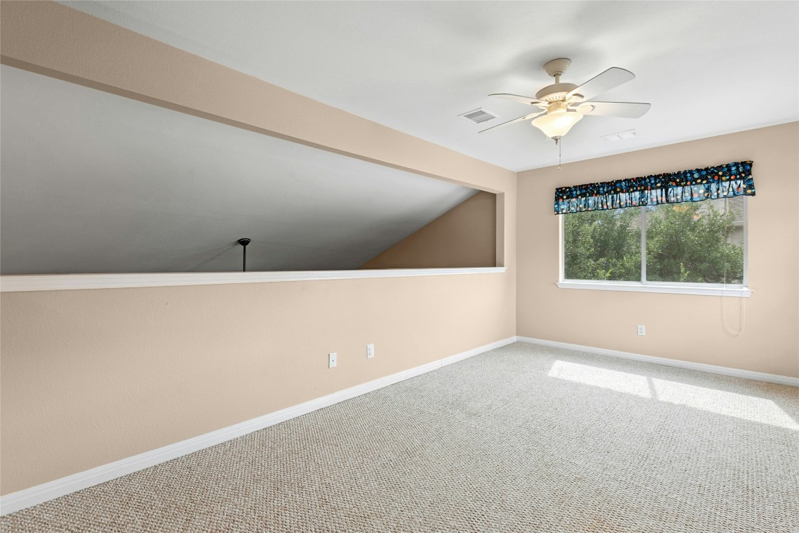7500 Shadowridge Run, Unit 34 Austin, TX 78749 - Photo 28 of 39 a view of an empty room with chandelier fan and window