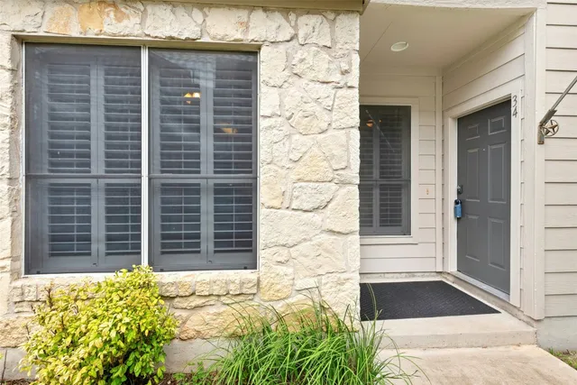 a view of a livingroom with wooden floor and staircase