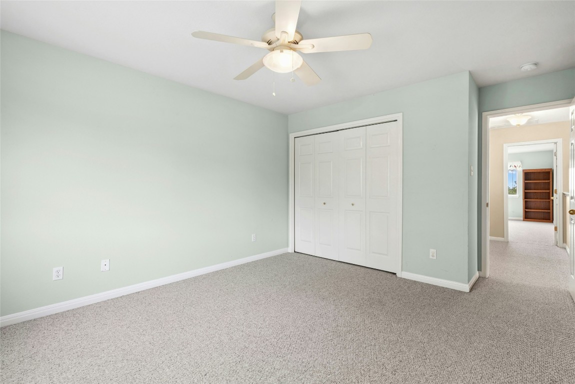 7500 Shadowridge Run, Unit 34 Austin, TX 78749 - Photo 32 of 39 an empty room with a ceiling fan and a fan