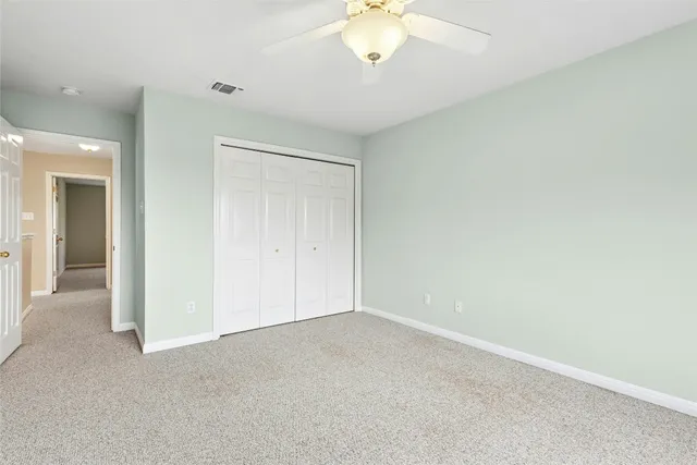 a patio with wooden floor a yard a table and chairs