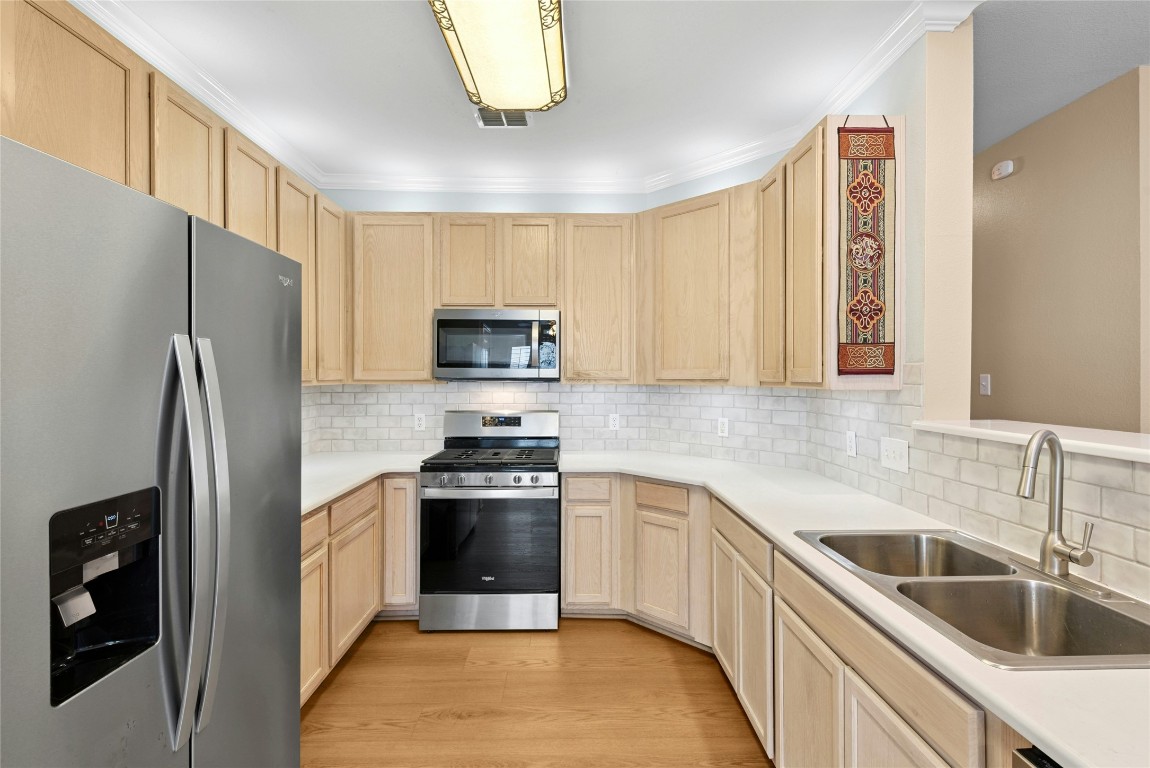 7500 Shadowridge Run, Unit 34 Austin, TX 78749 - Photo 7 of 39 a kitchen with stainless steel appliances granite countertop a refrigerator sink and stove