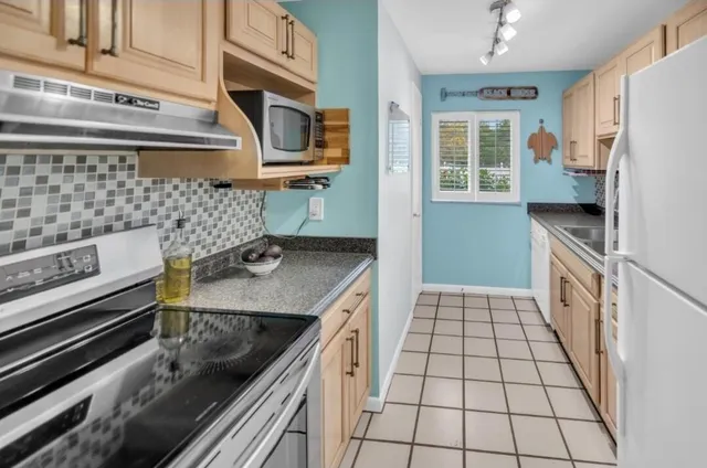 a kitchen with stainless steel appliances a sink stove and refrigerator