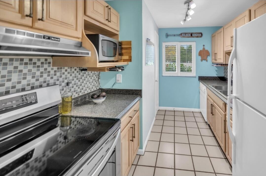 40 High Point Road, Unit C105 Tavernier, FL 33070 - Photo 2 of 8 a kitchen with stainless steel appliances a sink stove and refrigerator